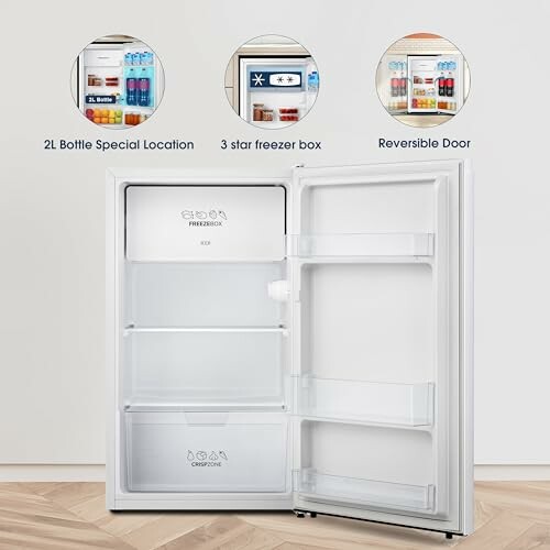 Open compact refrigerator showcasing features like 2L bottle space, 3-star freezer, and reversible door.