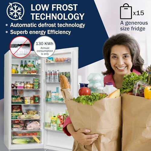 Woman holding groceries in front of an open fridge with low frost technology features.