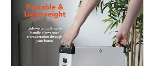 Person lifting a portable and lightweight heater with a carry handle.